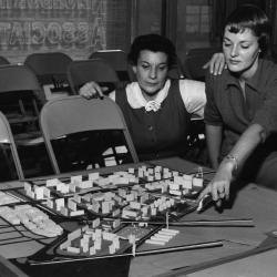 Ms Matilda Stein (left) and Ms. Phyllis Quackenbush, secretaries of the Lower East Side Neighborhood Association study a model of a project by Cooper Union architecture students. 